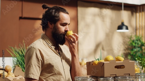 фотографія Man in sustainable bio farmers market feels dopamine rush while smelling lemons