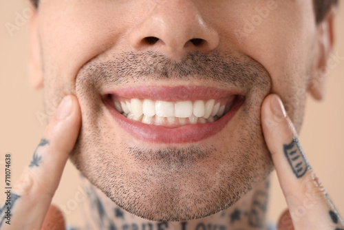 Young tattooed man with hea...