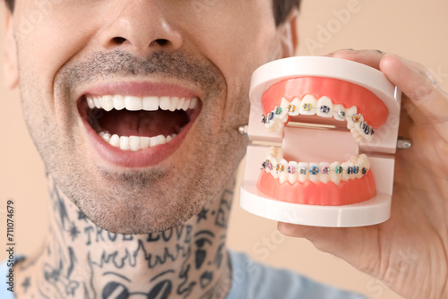 Young tattooed man holding ...