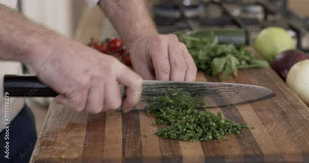 Chef, hands and chopping herbs for preparation on kitchen counter for nutrition, health or salad. Person, fingers and knife or cut vegetables on board or culinary cuisine diet, professional or skills Chef, hands and chopping herbs for preparation on kitchen counter for nutrition, health or salad. Person, fingers and knife or cut vegetables on board or culinary cuisine diet, professional or skills