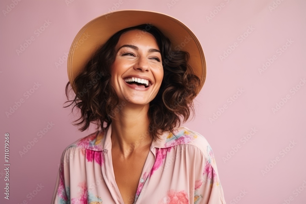 Portrait of a smiling young woman in summer hat over pink background Portrait of a smiling young woman in summer hat over pink background