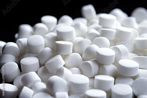 Close-up image of a pile of white water softener salt tablets