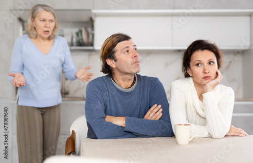 Elderly woman swears at married couple. Complex intergenerational relationships