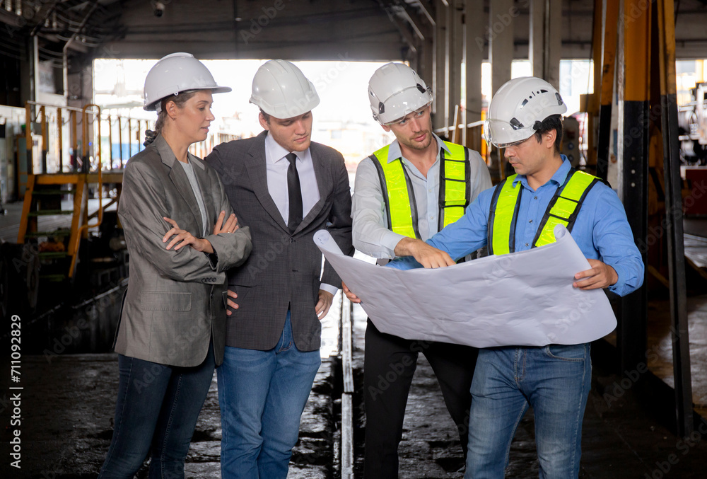 Team young caucasian engineer man and woman in checking train looking blueprint in station, team engineer inspect system transport, technician examining infrastructure, transportation and industry.