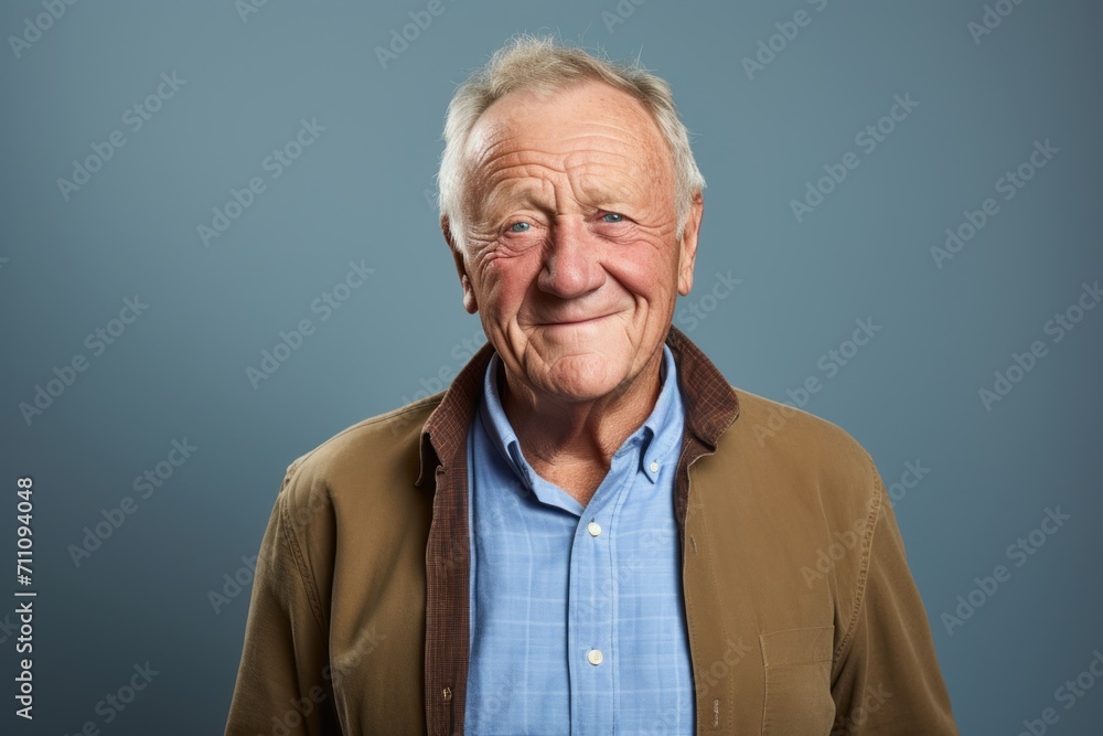 Portrait of a senior man with wrinkles on his face against blue background Portrait of a senior man with wrinkles on his face against blue background