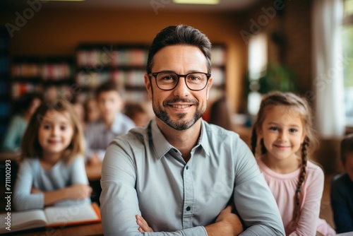 Male teacher with students in classroom photo