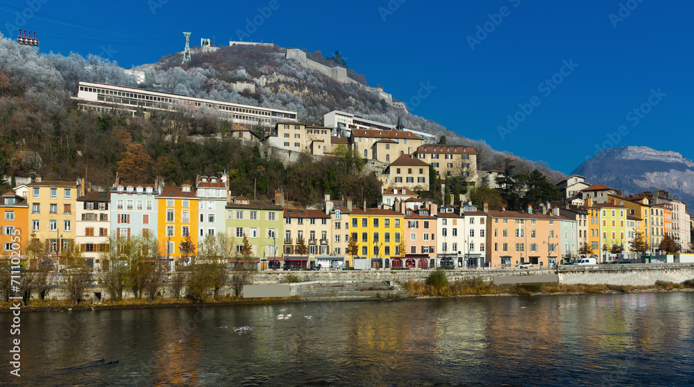 Cityscape of Grenoble with Bastille hill and famous cable car in sunny day, France