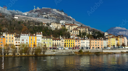 Cityscape of Grenoble with Bastille hill and famous cable car in sunny day, France © JackF