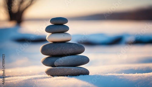 Stack of pebbles or stones on winter outdoor background for winter yoga
