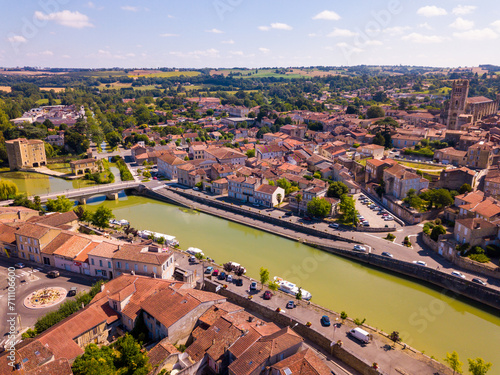 View from drone of modern cityscape of French commune of Condom on river Baise in summer