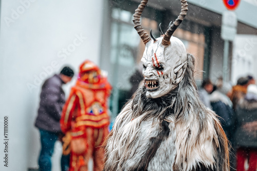 Carnival processions in Germany.Carnival costumes and characters. Krampus monster costumes on street background.Winter costume processions on the streets of Europe.Traditional cultural folklore photo