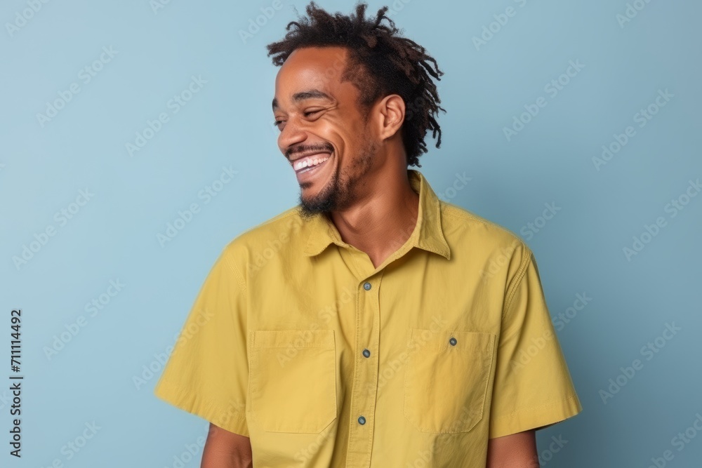 Portrait of a happy african american man laughing against blue background Portrait of a happy african american man laughing against blue background