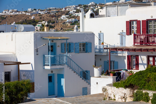 Streetview of Mykonos town with white street and blue door, Greece