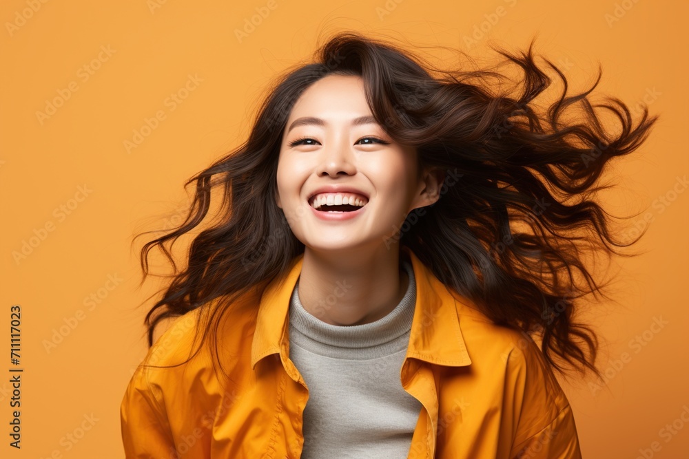 Portrait of a young Asian woman with long brown hair smiling happily Portrait of a young Asian woman with long brown hair smiling happily