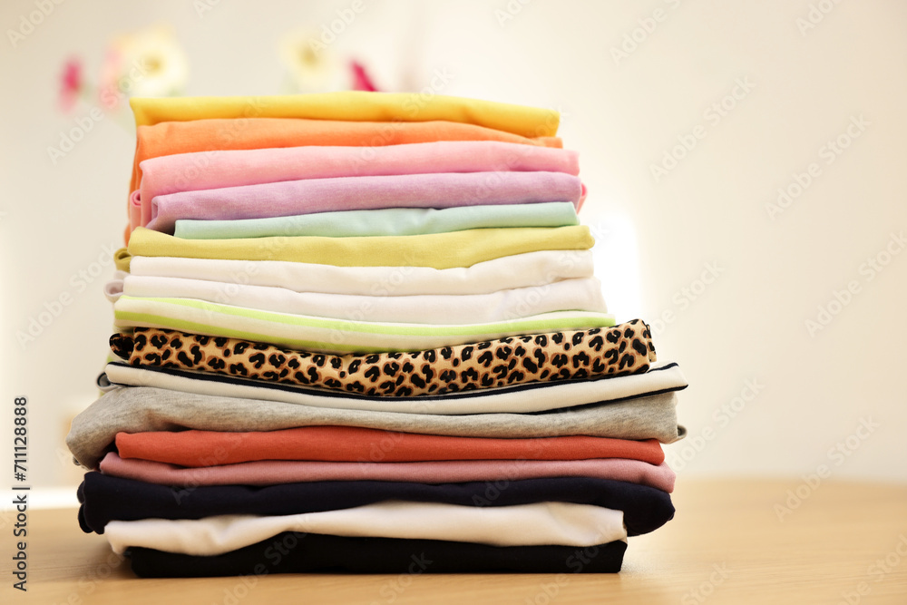 Stack of clean clothes on wooden table Stack of clean clothes on wooden table