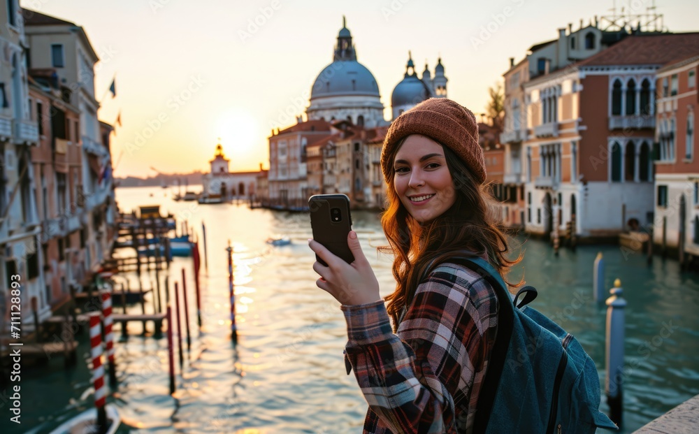Venetian Adventure: A Young Native Woman, Backpack Adorned, Captures the Joy of Traveling with a Selfie near a Venice Bridge - A Genuine Smile Amidst Italian Heritage.

