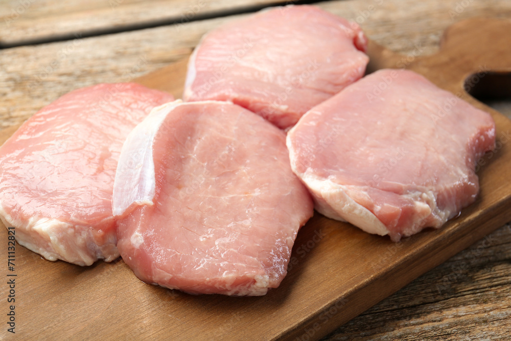 Pieces of raw pork meat on wooden table, closeup Pieces of raw pork meat on wooden table, closeup