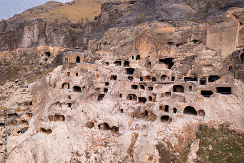 Complex of cave monastery structures carved into mountain in historic city of Vardzia, important archaeological site and tourist attraction in Georgia.. photo