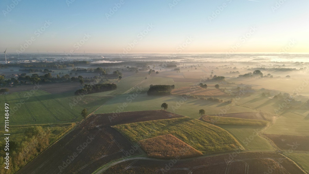 Aerial view of a morning on a farm covered in mist in Retie, Belgium