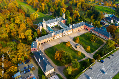 Scenic autumn landscape with large Castle complex near village of Sychrov with romantic neogothic building and English style park, Czech Republic.. photo