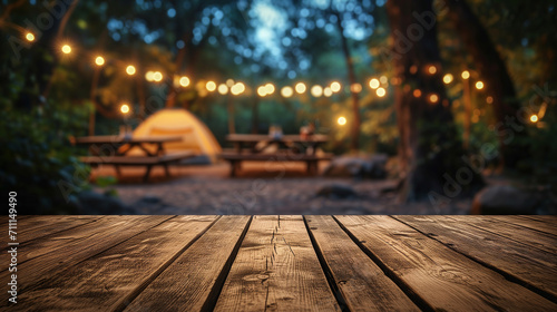 Wooden table on blur tent camping at night background photo