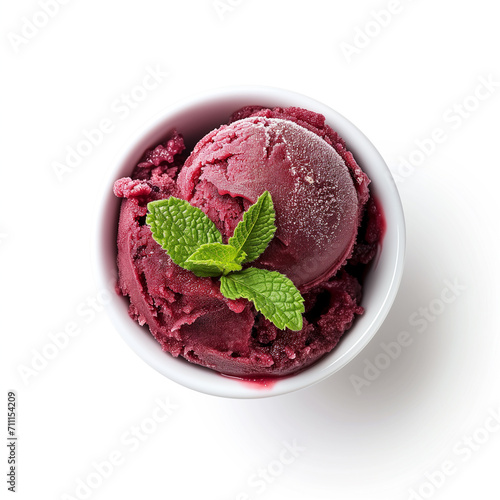 A cup of acai berry sorbet with a mint sprig top view isolated on a white background  photo