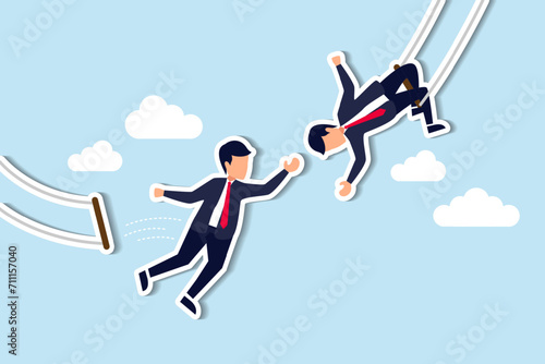 Trust, partnership and support to success in work, collaborate or cooperate teamwork, risk taking, unity or help to achieve target concept, businessman trapeze perform jumping and catch by partner.