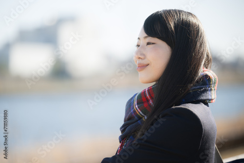 頑張れ受験生！マフラーをして屋外で見つめるかわいい女子高生の横顔　秋冬の受験のイメージ　横顔 photo