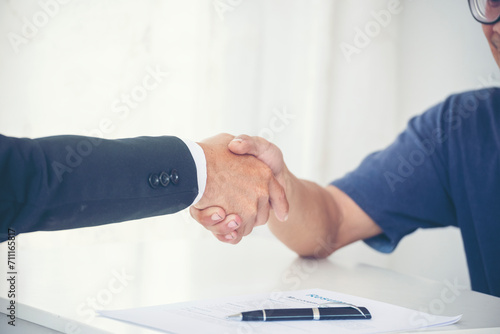 Close up hands Team Business Partners shaking hands together to Greeting Start up new project. Shakehand Teamwork Partnership office desk. Businessman partners handshake together. Business concept