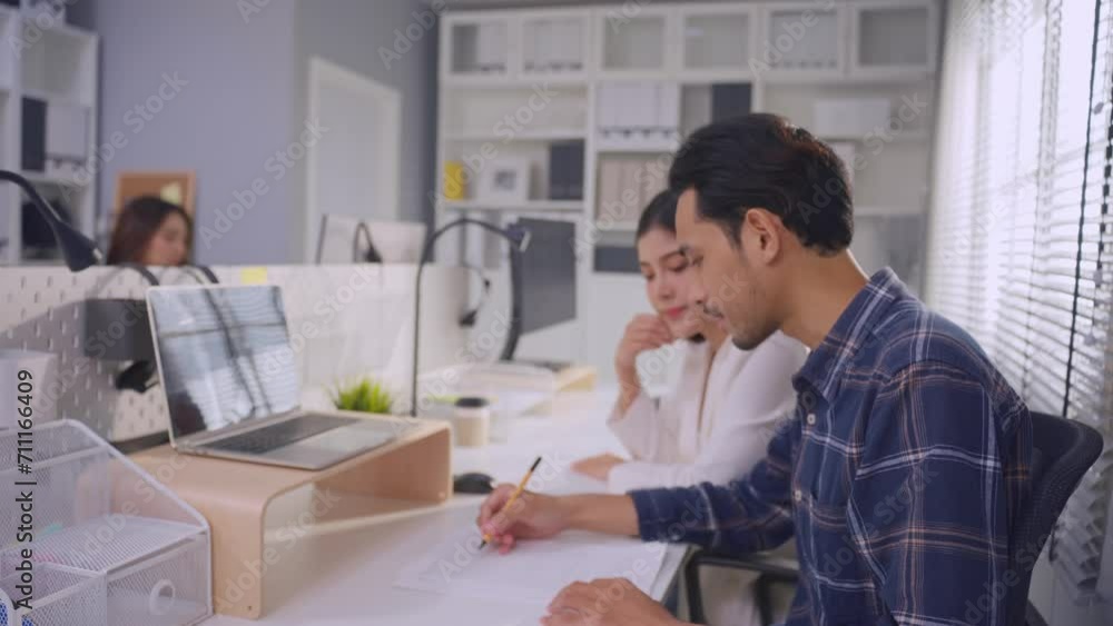 Young attractive businessman and businesswoman work in office workplace. Young attractive businessman and businesswoman work in office workplace.