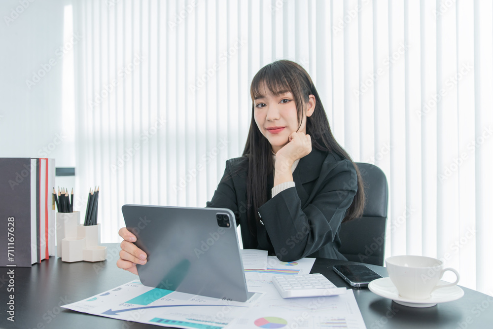 business woman working on the tablet ,discussing customer and checking business analytic document report working place in office. business woman working on the tablet ,discussing customer and checking business analytic document report working place in office.