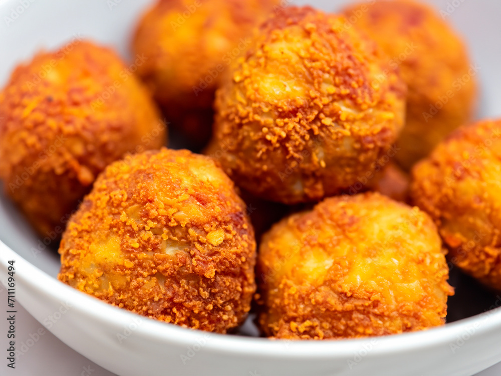 fried balls with pork meatballs in a white plate