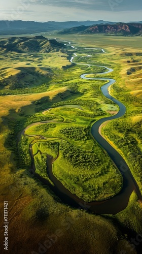 Serene River Flowing Through Vibrant Green Countryside Field