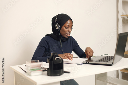Arabic entrepreneur working on a laptop in her office