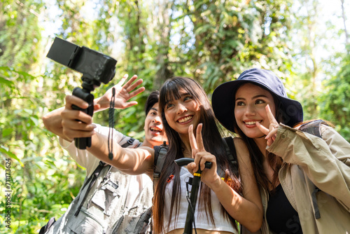 Group of Asian backpacker vlogger have fun travel in forest together. 