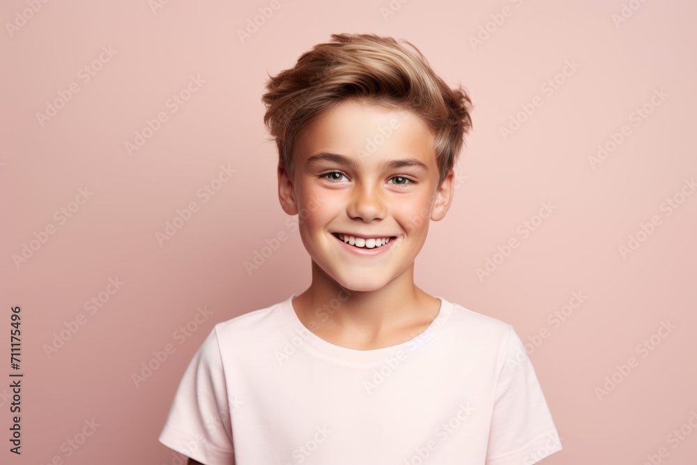 Portrait of a smiling teen boy on a pink background. Studio shot. Portrait of a smiling teen boy on a pink background. Studio shot.