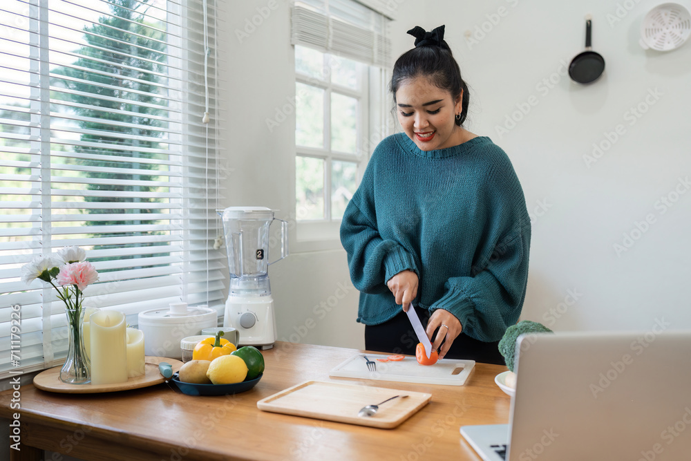 overweight Asian woman learning to make salad and healthy food from social media overweight Asian woman learning to make salad and healthy food from social media