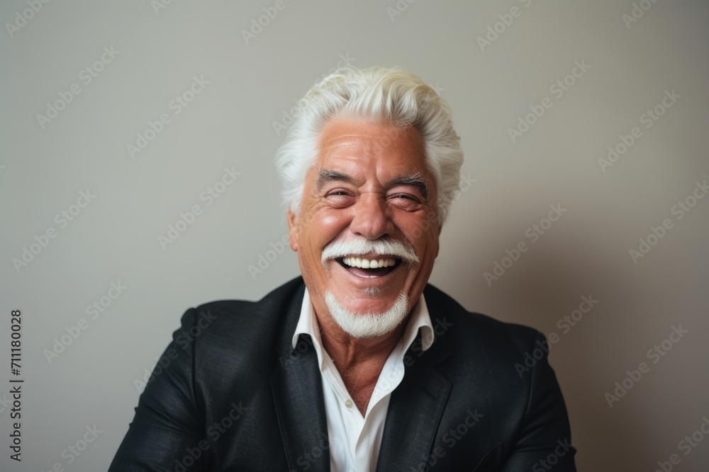 Portrait of happy senior man with white hair laughing and looking at camera. Portrait of happy senior man with white hair laughing and looking at camera.