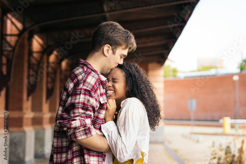 Reunited at last!: Young couple meeting at the station after a trip