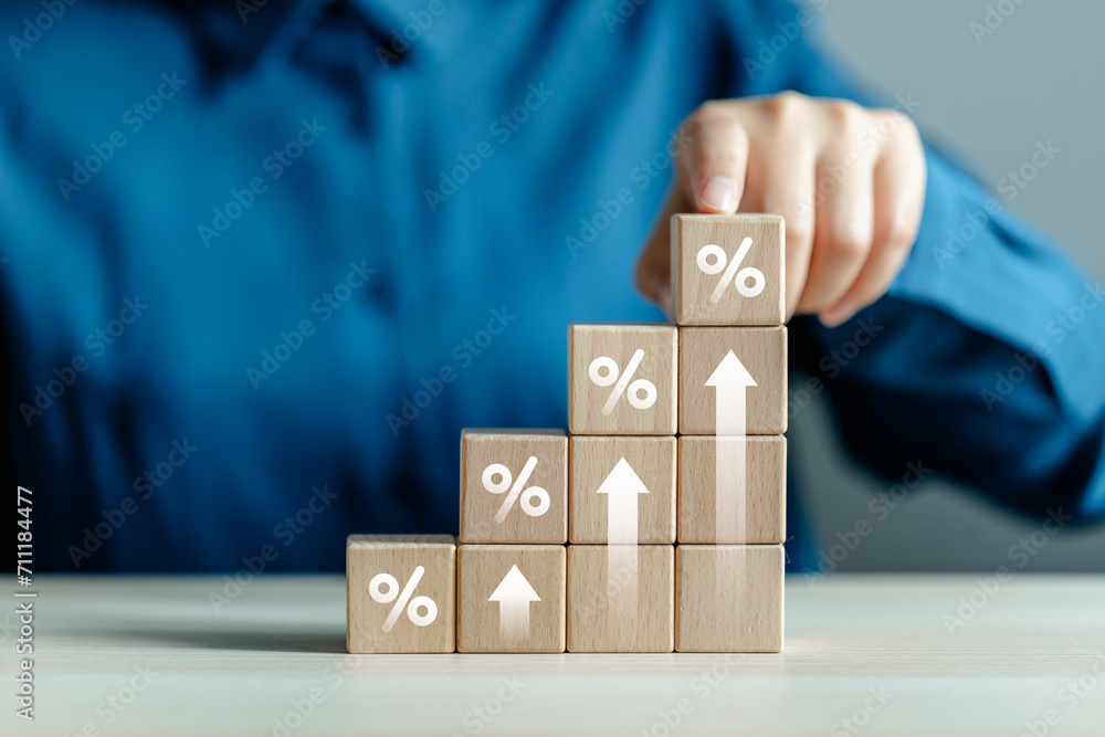 Wooden block with percentage sign and arrow up, Interest rate and dividend concept, interest rate, tax, VAT, real estate, return on stocks and mutual funds, business growth income and profit. - obrazy, fototapety, plakaty 