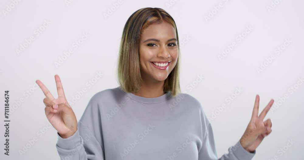 Peace hands, face and happy woman dance in studio with good news celebration on white background. V sign, freedom and portrait of female model with energy, music or positive attitude, mood and rhythm Peace hands, face and happy woman dance in studio with good news celebration on white background. V sign, freedom and portrait of female model with energy, music or positive attitude, mood and rhythm