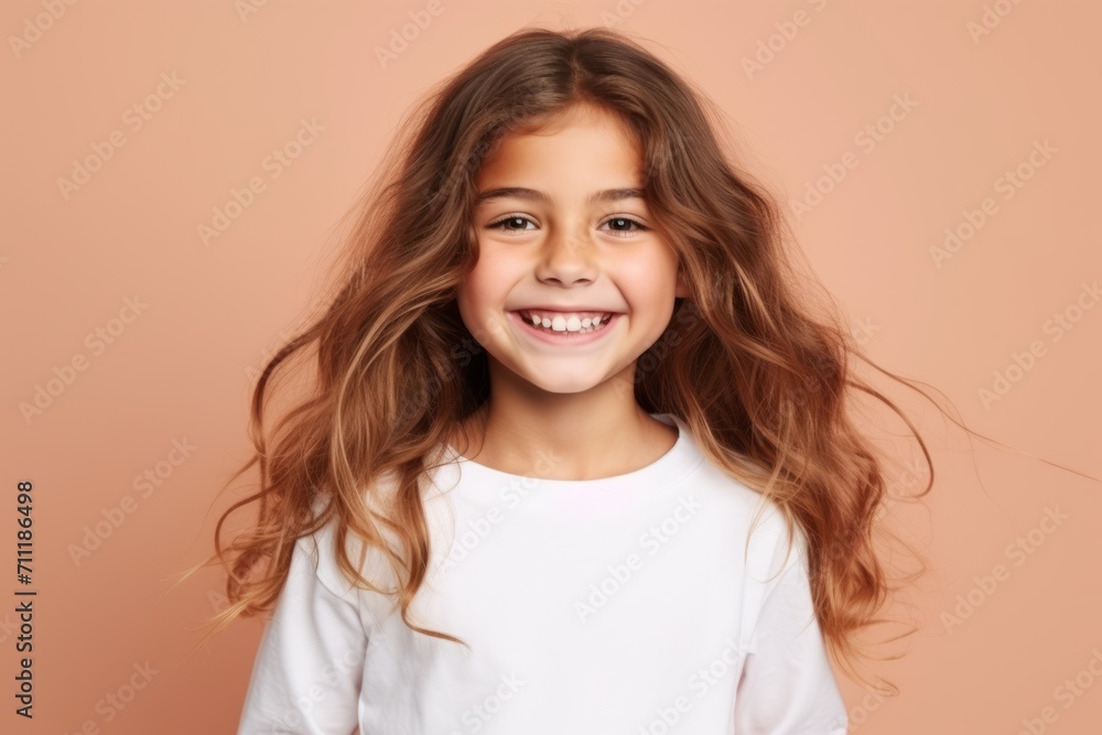Portrait of a cute little girl with long hair on a pink background Portrait of a cute little girl with long hair on a pink background
