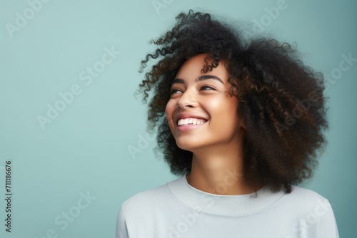 Beautiful african american woman with afro hairstyle on blue background © Inigo