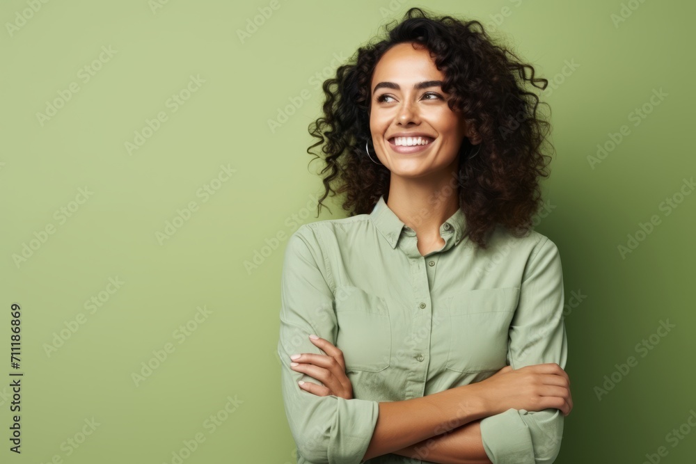 smiling african american woman with crossed arms on green background smiling african american woman with crossed arms on green background