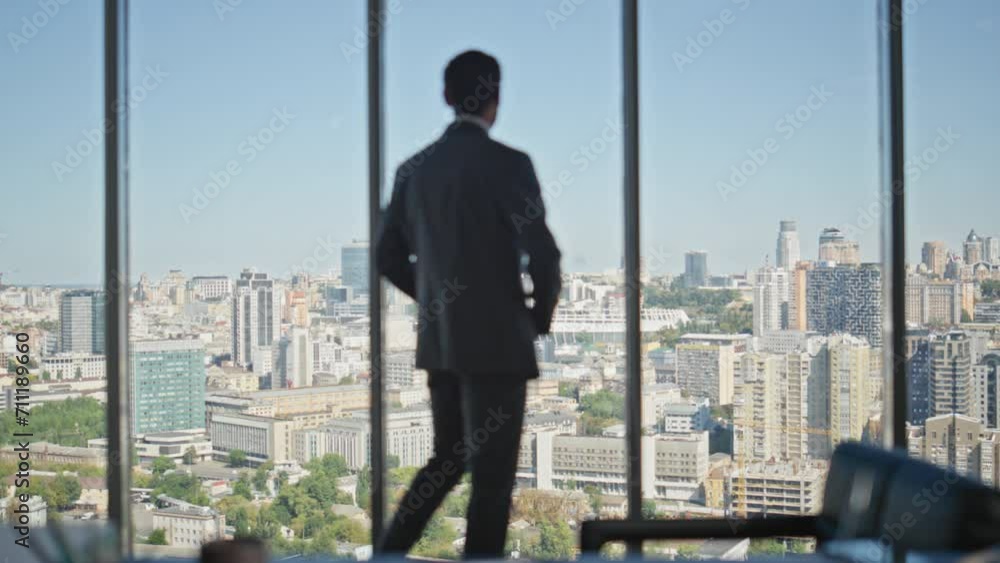 Nervous manager walking office room rear view. Pensive businessman looking city Nervous manager walking office room rear view. Pensive businessman looking city