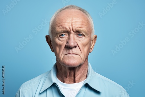 Portrait of a senior man. Isolated on blue background.