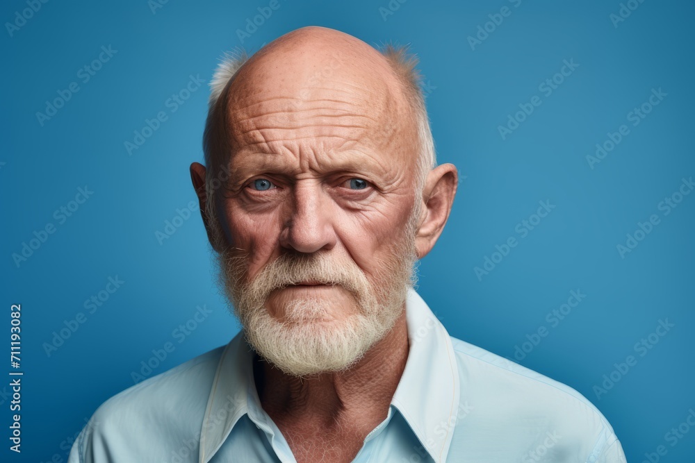 Portrait of senior man with white beard and mustache on blue background Portrait of senior man with white beard and mustache on blue background