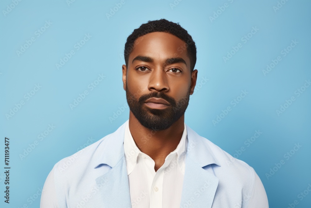Portrait of handsome African American man with beard and mustache on blue background Portrait of handsome African American man with beard and mustache on blue background