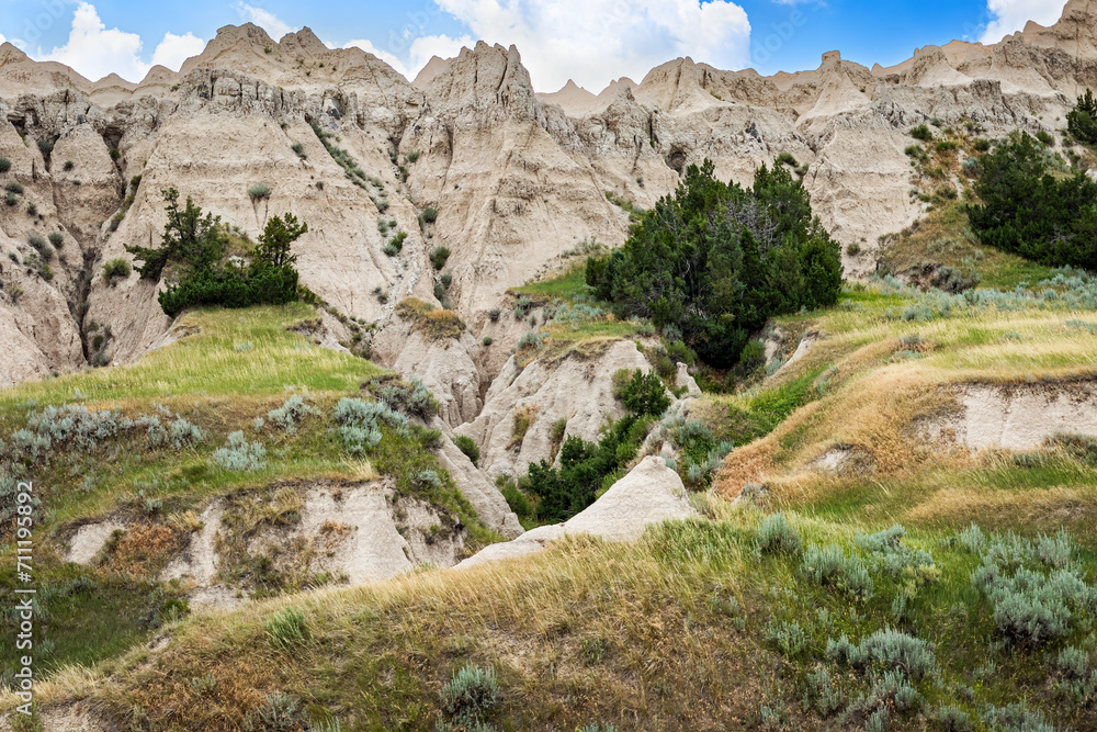 Deep ravine in the arid desert canyon landscape of the Badlands National Park of South Dakota during early summer.