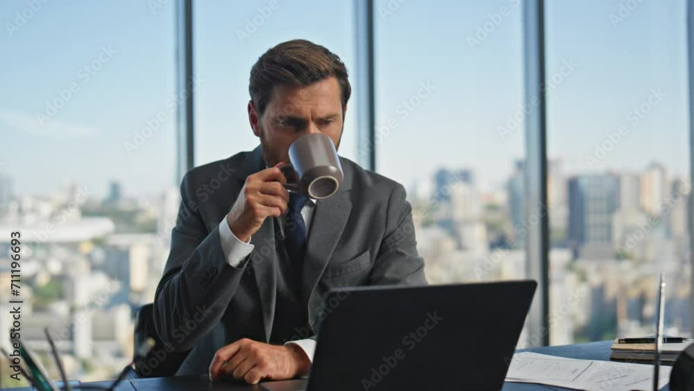 Mature leader calling laptop drinking coffee in morning. Pensive man talking Mature leader calling laptop drinking coffee in morning. Pensive man talking